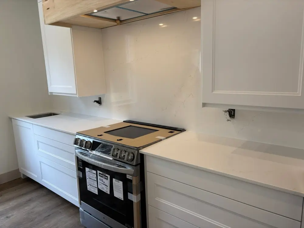 Countertop and backsplash just installed on white cabinets