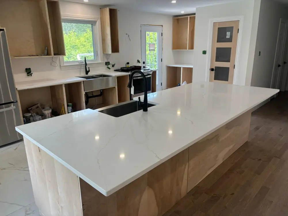 Large veined island with an undermount sink in a new build